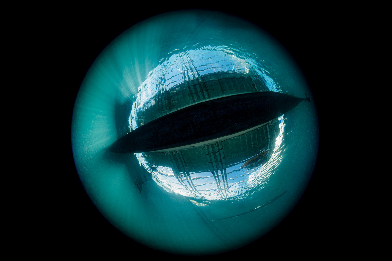 Circular fisheye over-under of a banca, Dauin