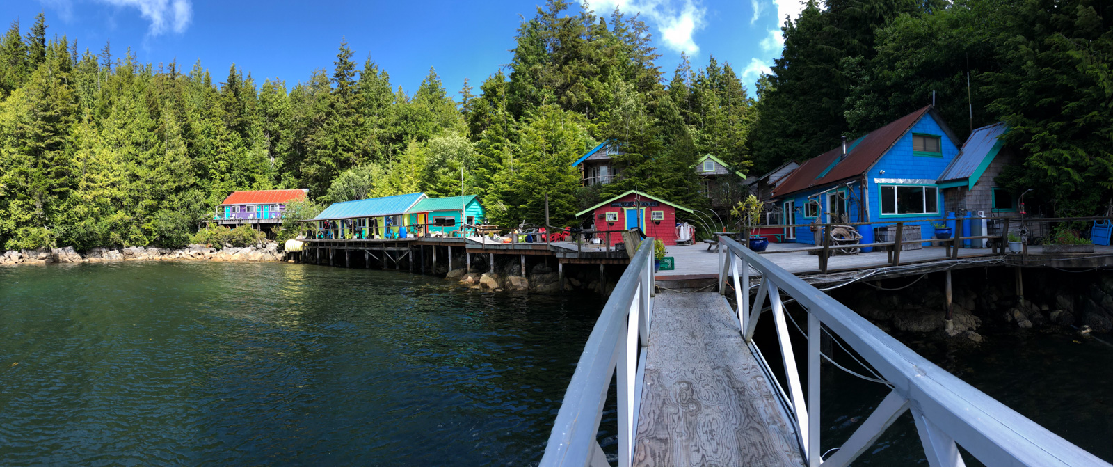 The ramp down to the dock, the painted buildings of the resort strung along the shore under the firs.