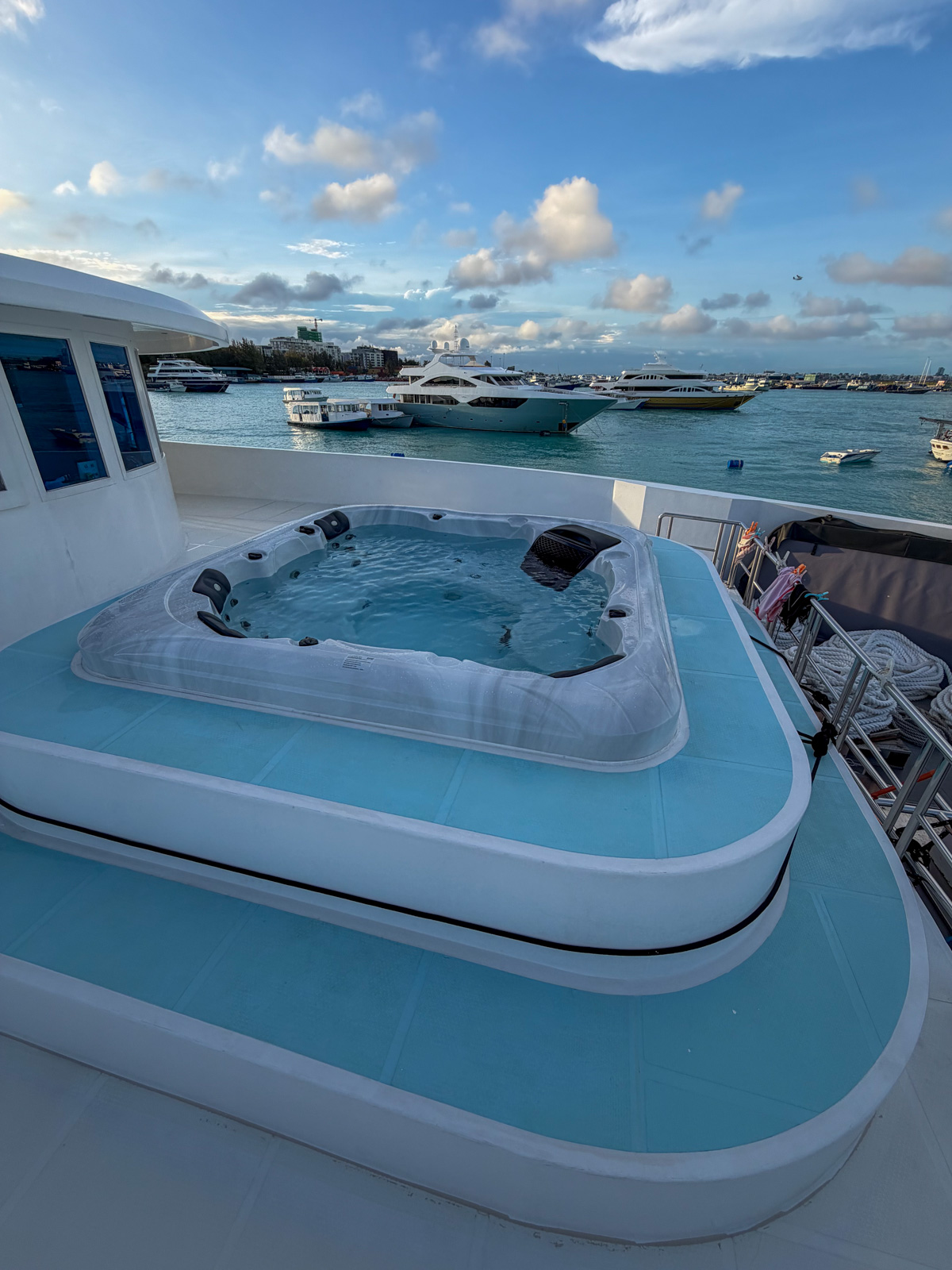 The jacuzzi on the sundeck, the harbour and the rest of the fleet beyond the rail.
